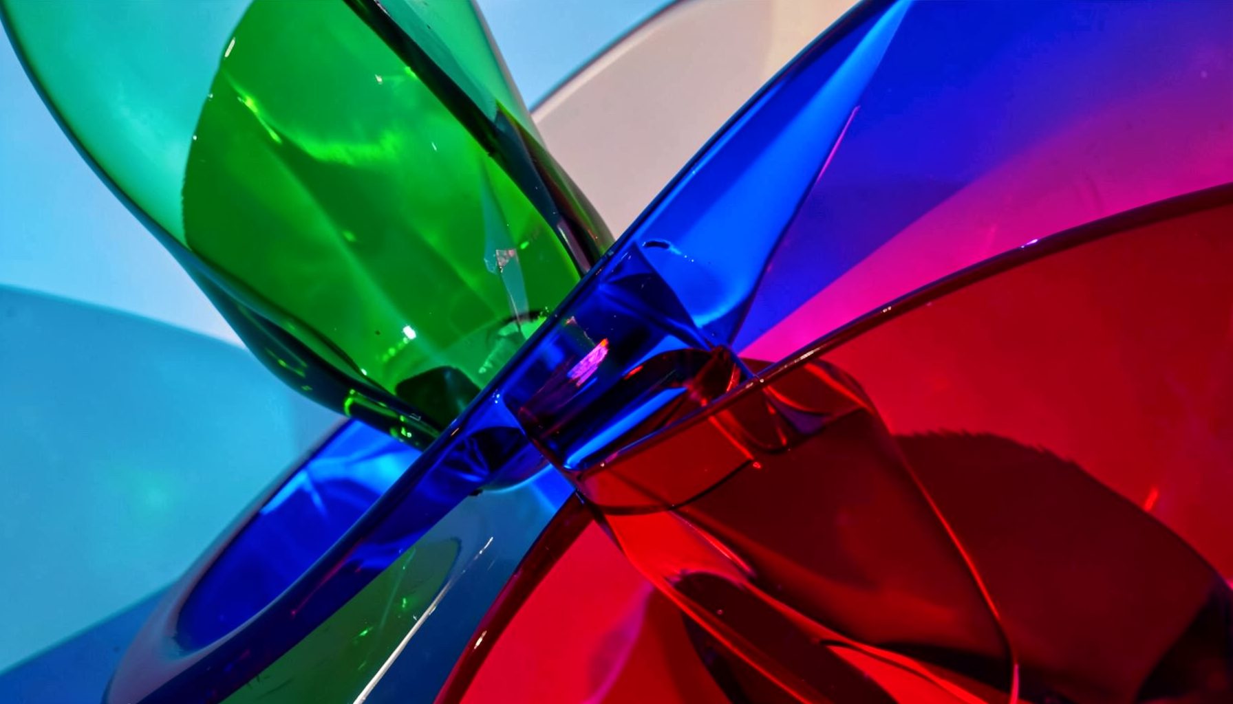 Vibrant jewel tones — emerald, sapphire, and ruby — in a dynamic abstract dance-inspired composition